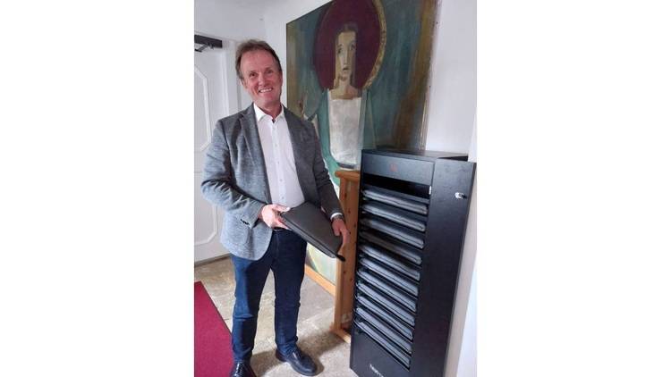 ALT-Text: „Fachplaner überprüft die Systemleistung eines intelligenten Gebäudeautomationsschranks mithilfe eines Laptops, ideal zur Illustration moderner Heizungs-, Lüftungs- und Klimatechniklösungen.