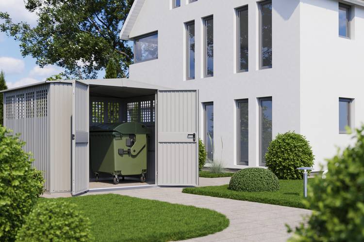 Alt-Text: „Moderner Metallunterstand mit integriertem Abfallbehälter neben einem energieeffizienten, weißen Gebäude, umgeben von nachhaltiger Grünfläche – Beispiel für umweltfreundliche Gebäudetechnik.“.