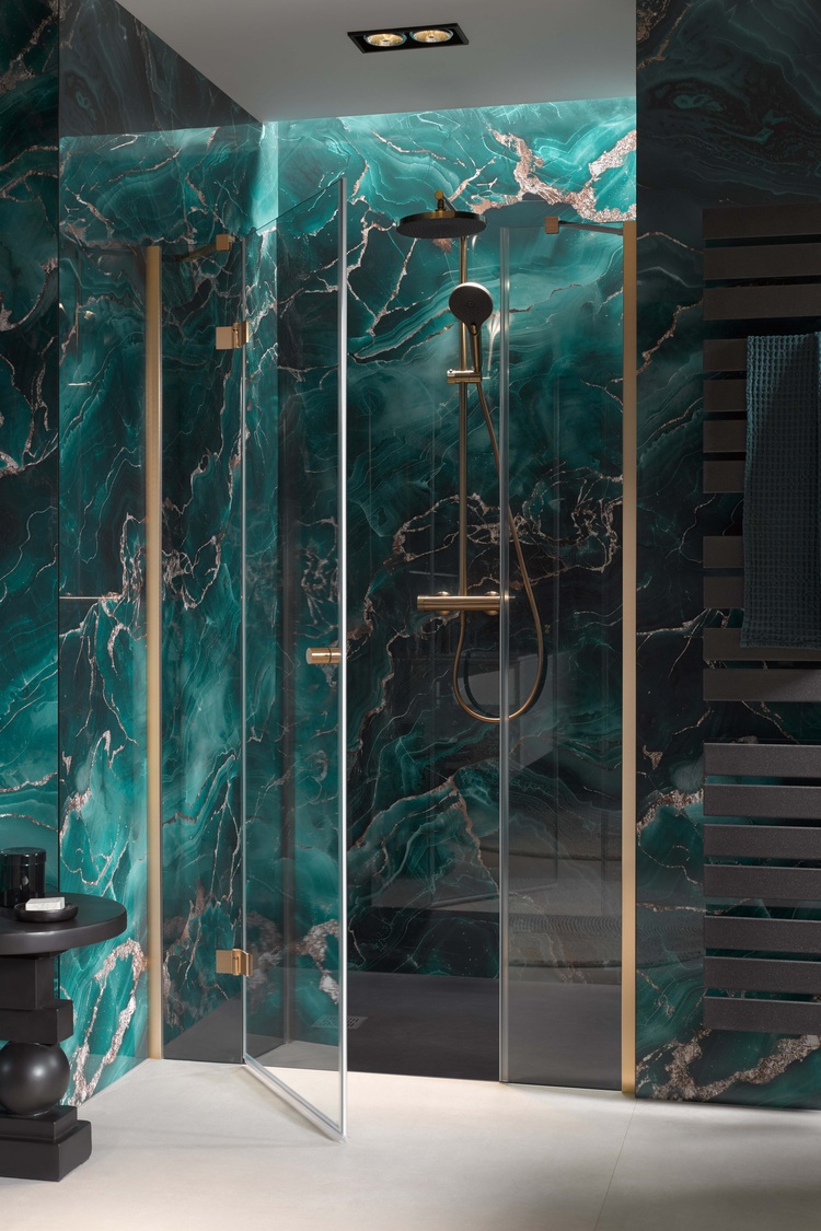 Barrierefreie Glasdusche mit goldenen Armaturen, modernen Elementen und auffälligen türkisfarbenen Marmorwänden in zeitgemäßem Bad-Design.