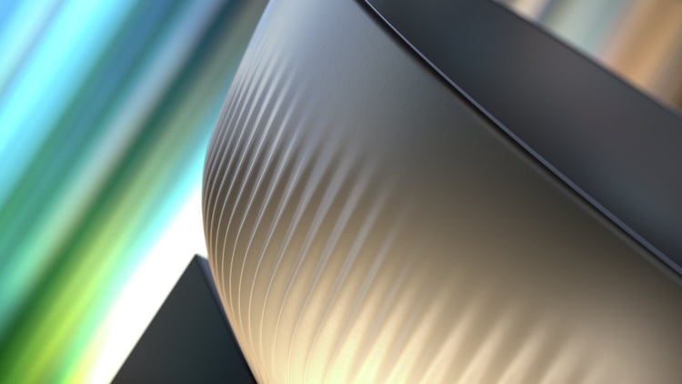 Detailaufnahme einer glatten, geriffelten Metallschale, typisches Material in der Gebäudetechnik; verschwommene farbige Streifen im Hintergrund.