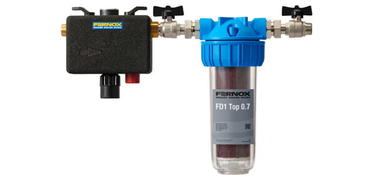 Fernox FD1 Top 0.7 Heizungsfilteranlage mit blauer Kappe, an Metallrohre angeschlossen – geeignet für eine effiziente Systemfilterung in Gebäuden.