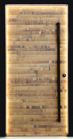 Das Sondermodell HT 3-82 in Fasseiche mit Griff in Schwarzstahl und mit im Rahmen integrierter LED-Beleuchtung ist mit dem Zugangssystem „Smart Connect“, Motorschloss und verdeckt liegenden Bändern ausgestattet. 