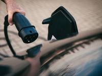 Hand hält Ladestecker